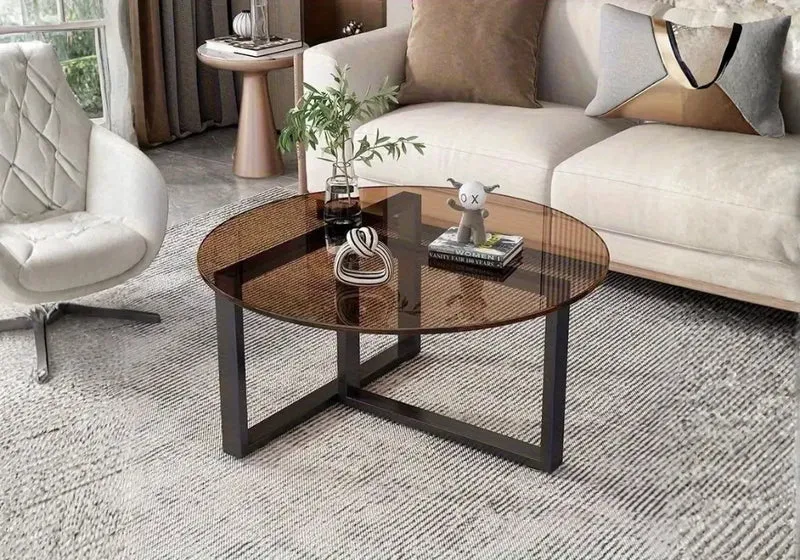 Table basse en verre teinté ambré avec piètement croisé noir mat